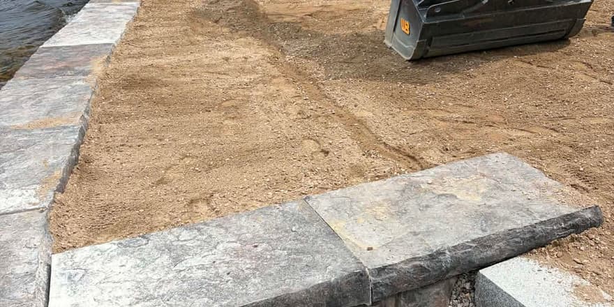 Stone retaining wall under construction on the lakefront