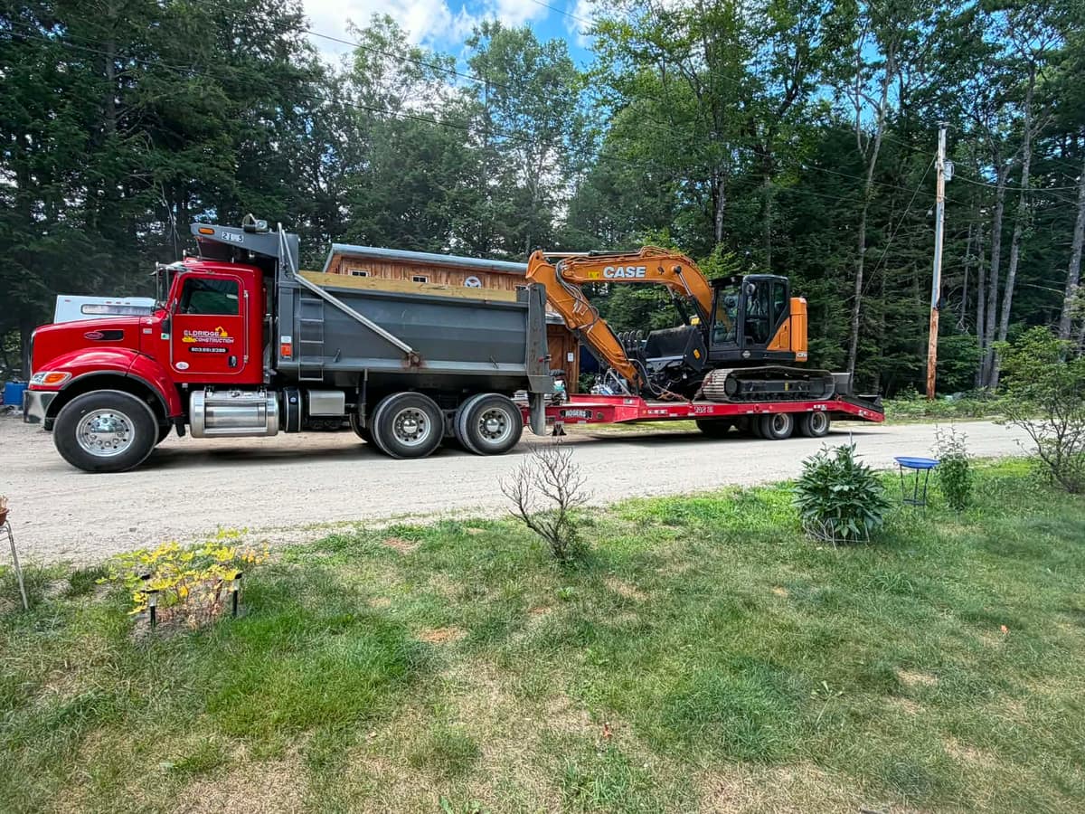 Eldridge Construction dump truck hauling excavator